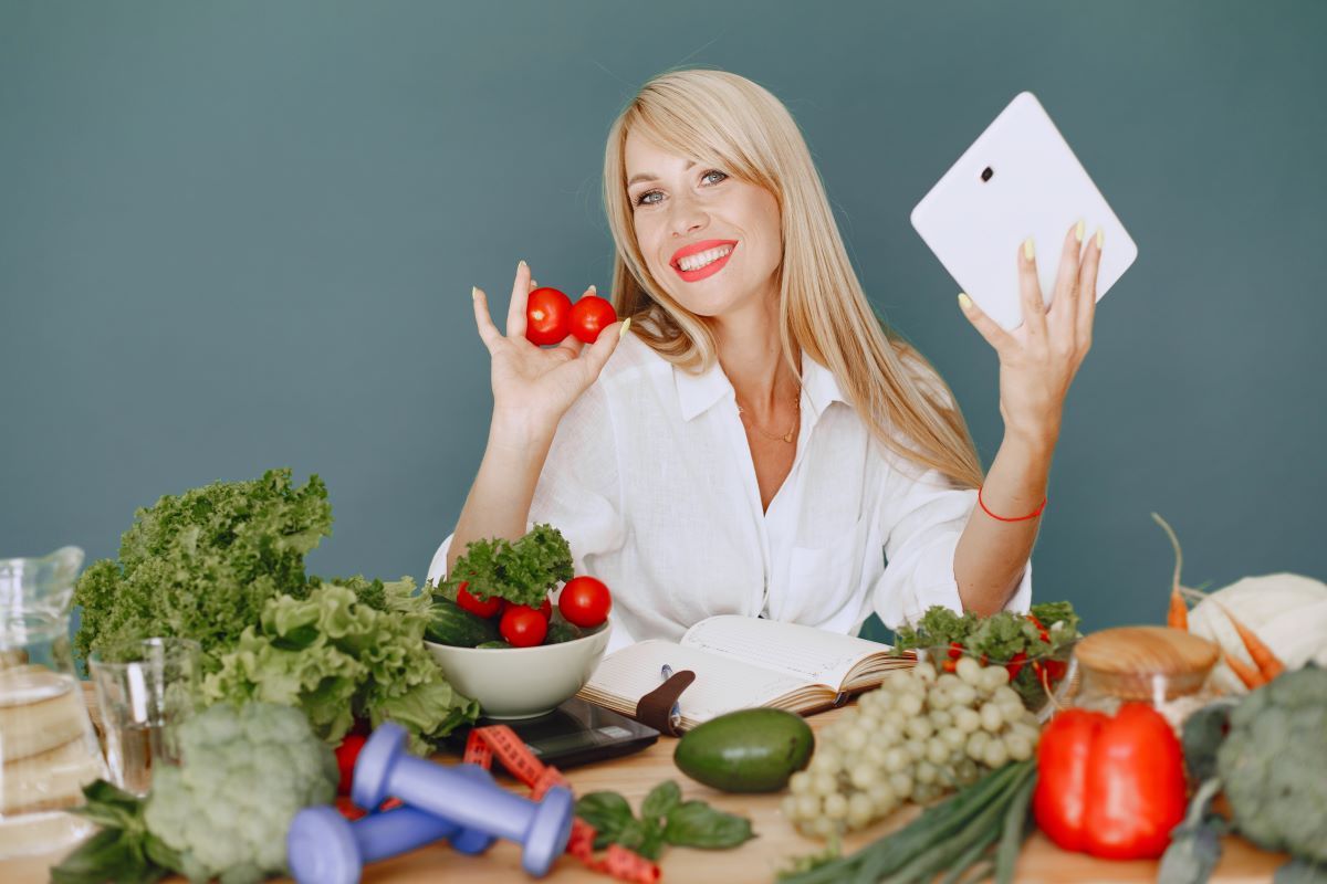 beautiful girl make salad sporty blonde kitchen woman writing recipe notebook