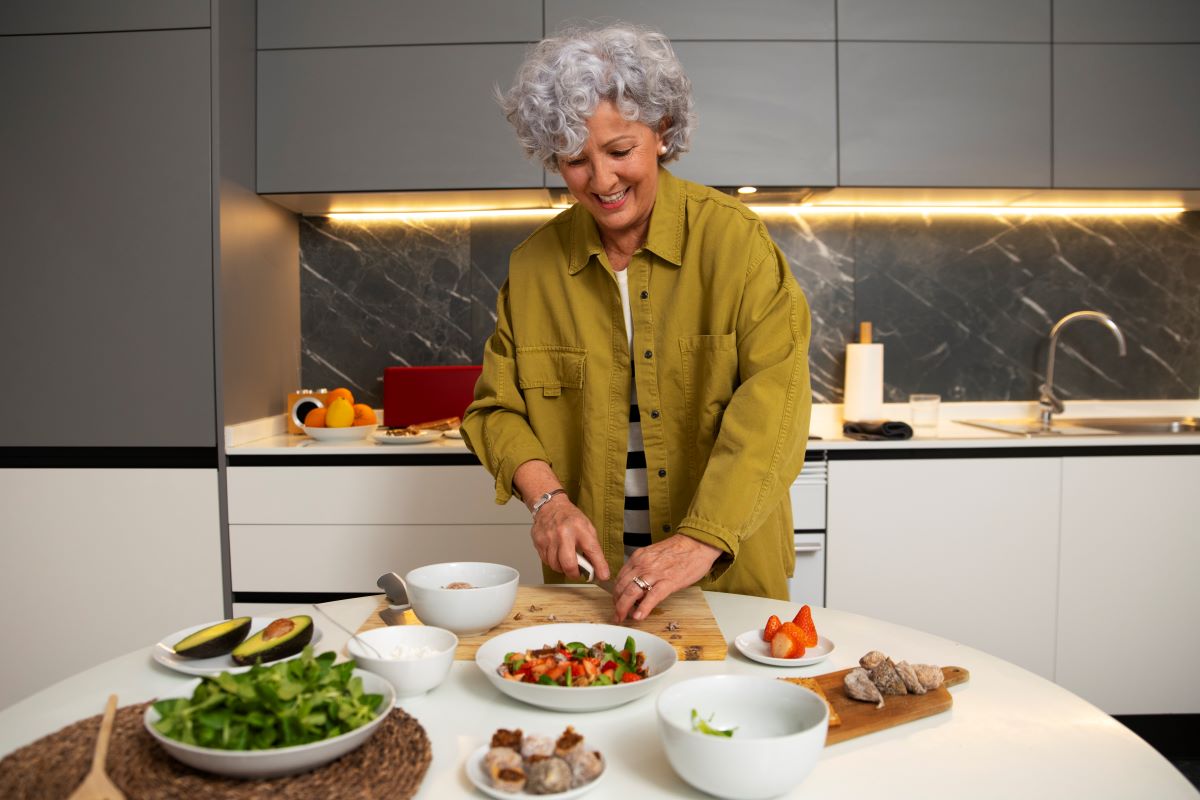 senior woman making dish with figs kitchen